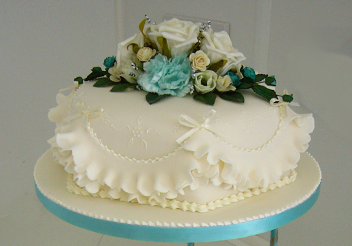A traditional Wedding Cake with blue and white flowers